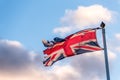 British Flag with torn edges waving over cloudy sky Royalty Free Stock Photo