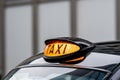 A british london black taxi cab sign with defocused  background Royalty Free Stock Photo