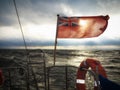 British maritime ensign flag boat and stormy sky