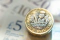 British money. Macro photo of One Pound coins and the British pound banknotes of different denomination Royalty Free Stock Photo