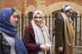 British Muslim Female Friends Walking In Urban Environment