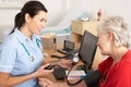 British nurse taking woman's blood pressure