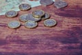 British one pound coins on wooden background Royalty Free Stock Photo