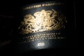 British passport very low key image. A dark and moody image with selective focus on the words Great Britain.