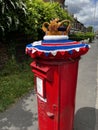 A British postbox in Manchester decorated for the Queen`s Platinum Jubilee Royalty Free Stock Photo