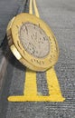 British pound coin on double yellow lines parking