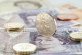 British Pound (GBP) coin Pound notes close-up. Coins on a banknote as a financial. Royalty Free Stock Photo