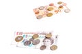 British Pound notes and coins and Euro notes and coins on white Royalty Free Stock Photo