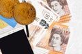 10 British pounds bills and golden bitcoins with smartphone and credit cards. Cryptocurrency investment concept. Crypto mining or