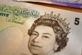 British queen on 5 british pounds-bank note