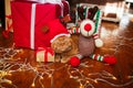 British red cat in Santa hat lying with a Christmas garland near gifts at home. Christmas cat Royalty Free Stock Photo