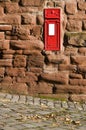 British red mail box mounted into stone wall. Royalty Free Stock Photo