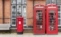 British red telephone booths beside a red post box in Stratford upon Avon, Warwickshire, England UK Royalty Free Stock Photo
