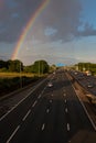 British road transport. Rainbow above motorway.