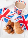 British sausage sandwich with, brown sauce, cup of tea and flag