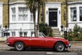 British scene. English scene. MG B classic car parked outside townhouse Royalty Free Stock Photo
