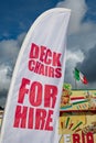 British seaside scene with deckchair hire sign