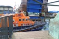 British lifeboat cruising under raised bridge