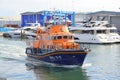 British lifeboat cruising through harbour