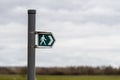 A British sign showing the direction of a public footpath Royalty Free Stock Photo