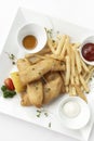 british traditional fish and chips meal in restaurant on white plate Royalty Free Stock Photo