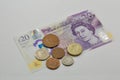 British twenty pounds banknote and coins closeup