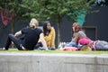 Brits chilling up after work on grass at South Bank in London