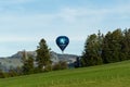 Brixen im Thale, Tirol/Austria - September 26 2018: Dark blue Alpen Bank branded balloon floating low above the Austrian hills