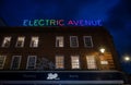 Brixton, London, UK: Electric Avenue in Brixton at night with neon sign