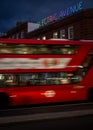 Brixton, London, UK: A bus with movement blur on Brixton Road at night at the junction with Electric Avenue