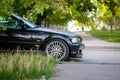 Front side view with wheel of black sports car on the street Royalty Free Stock Photo