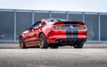 Red Ford Mustang in the parking lot. Powerful fast sports car.