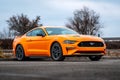 Yellow Ford Mustang in the parking lot. Powerful fast sports car.