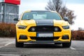 Yellow Ford Mustang in the parking lot. Powerful fast sports car.