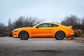 Yellow Ford Mustang in the parking lot. Powerful fast sports car.