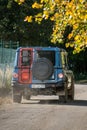 The rugged Ineos Grenadier off-road vehicle in the forest and on a dirt road