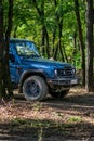 The rugged Ineos Grenadier off-road vehicle in the forest and on a dirt road