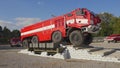 Brno, Czechia - October 08, 2021: Red heavy armoured fire fighting vehicle driving over obstacles. Demonstration for public at