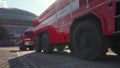 Brno, Czechia - October 08, 2021: Red heavy armoured fire fighting vehicles moving over stone road, closeup detail from low