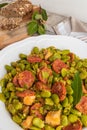 Broad bean with chorizo on vintage background. Typical portuguese food