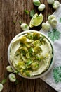 Broad bean hummus with addition of olive oil and resh mint on plate