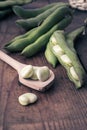 Broad Beans on a wooden Table with Jar, full of dry beans Royalty Free Stock Photo