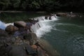 A broad dam spans across the river