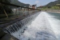 A broad dam spans across the river Royalty Free Stock Photo