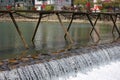 A broad dam spans across the river