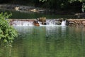 A broad dam spans across the river