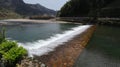 A broad dam spans across the river Royalty Free Stock Photo