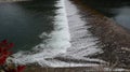 A broad dam spans across the river