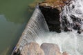 A broad dam spans across the river