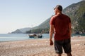 Broad-shouldered man posing at the turkish beach